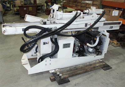 White Simco Earthprobe 200 drilling machine in warehouse with hydraulic hoses and control panel