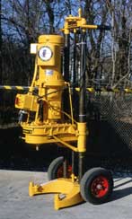 Yellow Mobile Minuteman compact drilling unit with vertical mast and hydraulic components